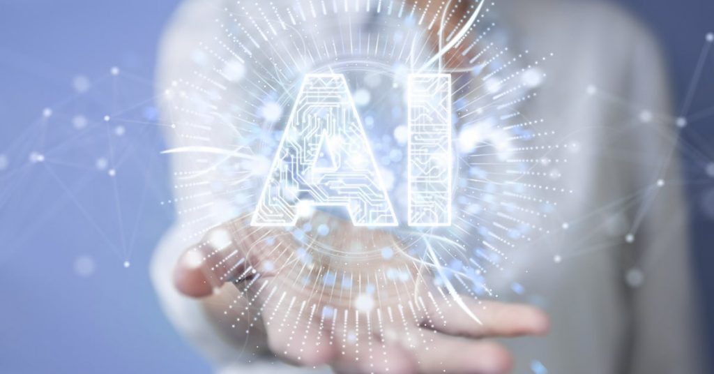 Letter AI in open hand of man with body in blurred background.